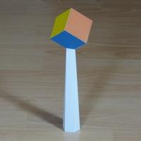 Paper model cube on pedestal