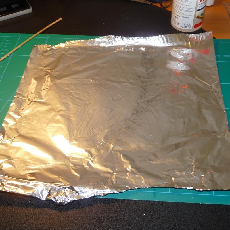 2. Unfold<br />3. Glue a large sheet of aluminium foil on the the model.